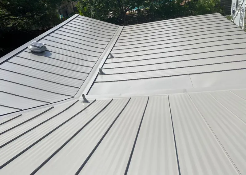 Solar attic fan installed on a metal roof for Roof Ventilation in Silver Lake